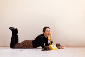 lauren laying on the floor with her legs up, talking on the phone to her seo clients