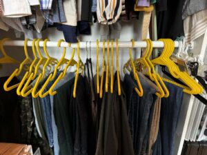 my closet full of yellow rex hangers.